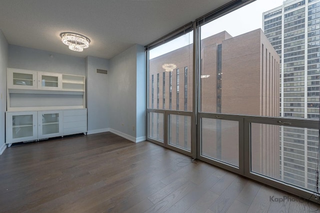 222 N Columbus Dr Unit 2808, Chicago, IL 60601 - unfurnished living room with wood finished floors, baseboards, a wall of windows, and a textured ceiling