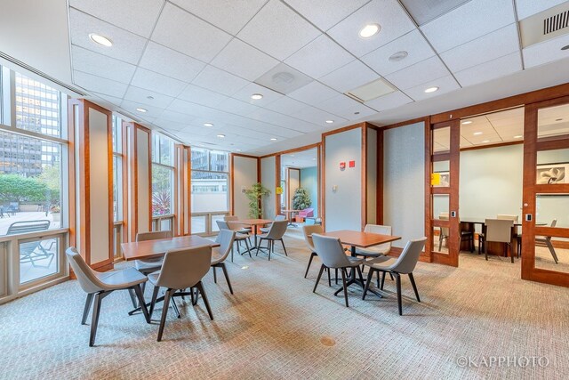 222 N Columbus Dr Unit 2808, Chicago, IL 60601 - dining space featuring light colored carpet and a wall of windows