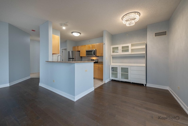 222 N Columbus Dr Unit 2808, Chicago, IL 60601 - kitchen featuring appliances with stainless steel finishes, a textured ceiling, dark wood-type flooring, baseboards, and a sink