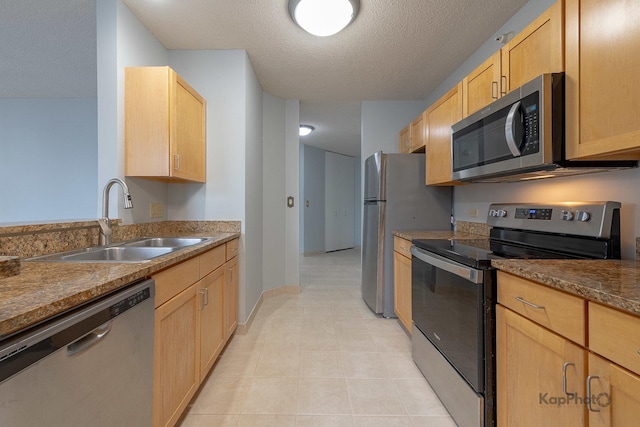 222 N Columbus Dr Unit 2808, Chicago, IL 60601 - kitchen with stainless steel appliances, a sink, light brown cabinetry, a textured ceiling, and dark countertops