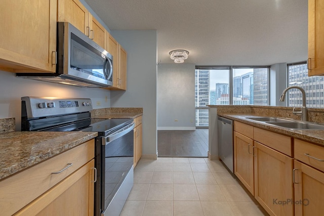 222 N Columbus Dr Unit 2808, Chicago, IL 60601 - kitchen with appliances with stainless steel finishes, a sink, baseboards, light tile patterned floors, and dark countertops