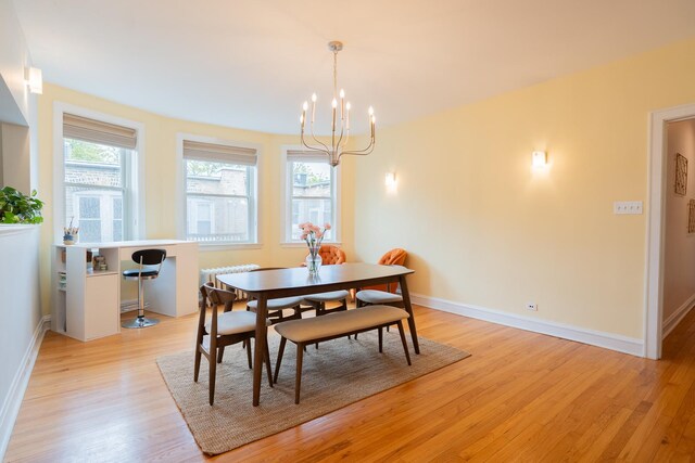 6652 N Glenwood Ave Unit 3N, Chicago, IL 60626 - dining area featuring light wood-style floors, a chandelier, and healthy amount of natural light