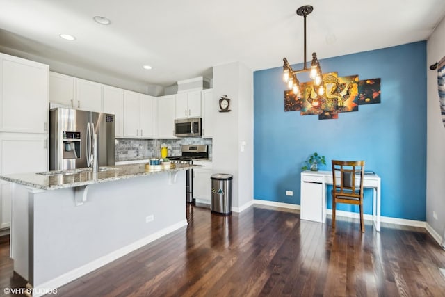 14 E Moseley Rd, Palatine, IL 60074 - kitchen with stainless steel appliances, dark wood-type flooring, tasteful backsplash, white cabinets, and light stone counters