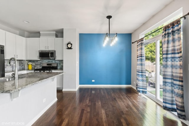 14 E Moseley Rd, Palatine, IL 60074 - kitchen featuring stainless steel appliances, a sink, dark wood finished floors, light stone counters, and white cabinetry