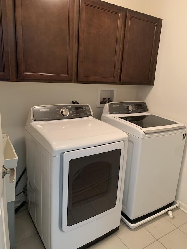 14 E Moseley Rd, Palatine, IL 60074 - laundry room featuring washing machine and clothes dryer, light tile patterned flooring, cabinet space, and baseboards