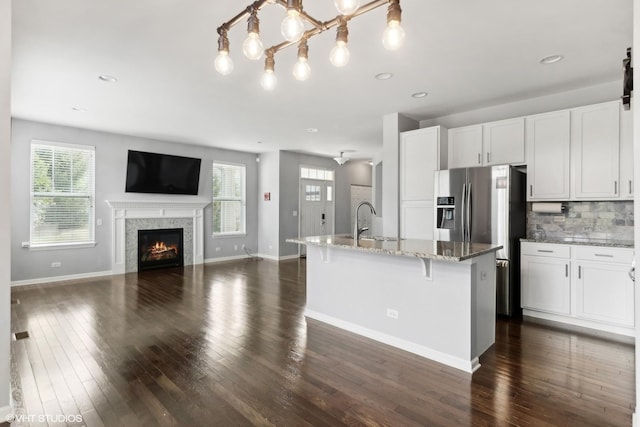 14 E Moseley Rd, Palatine, IL 60074 - kitchen featuring stainless steel fridge with ice dispenser, dark wood-type flooring, light stone counters, baseboards, and recessed lighting
