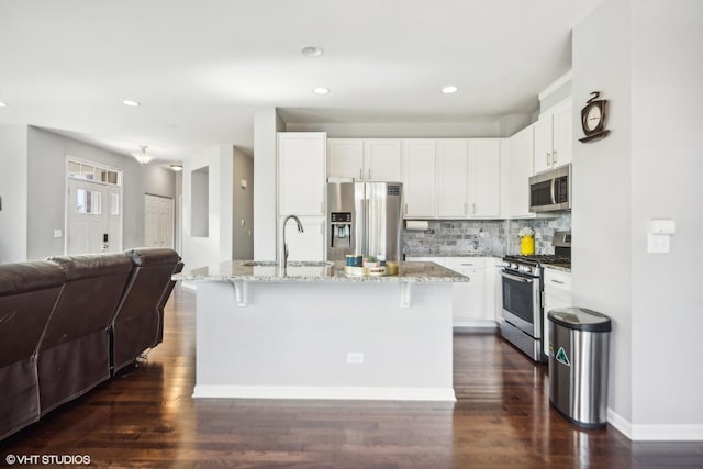14 E Moseley Rd, Palatine, IL 60074 - kitchen with appliances with stainless steel finishes, a sink, open floor plan, light stone counters, and white cabinetry