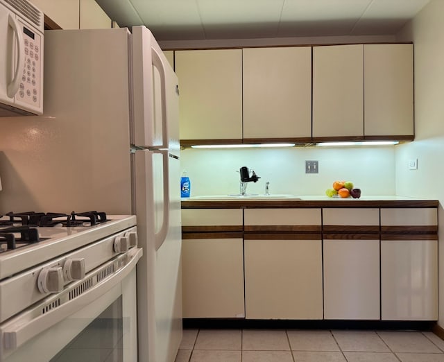 477 Graceland Ave Unit 2F, Des Plaines, IL 60016 - kitchen with a sink, white appliances, light tile patterned floors, light countertops, and white cabinets