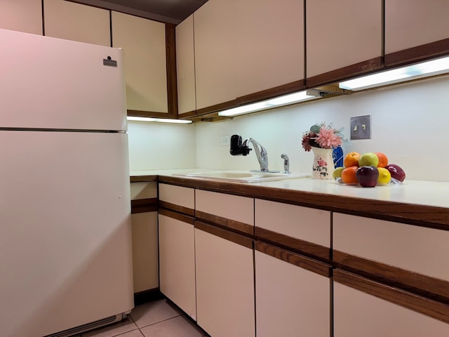 477 Graceland Ave Unit 2F, Des Plaines, IL 60016 - kitchen with freestanding refrigerator, a sink, white cabinets, and light countertops