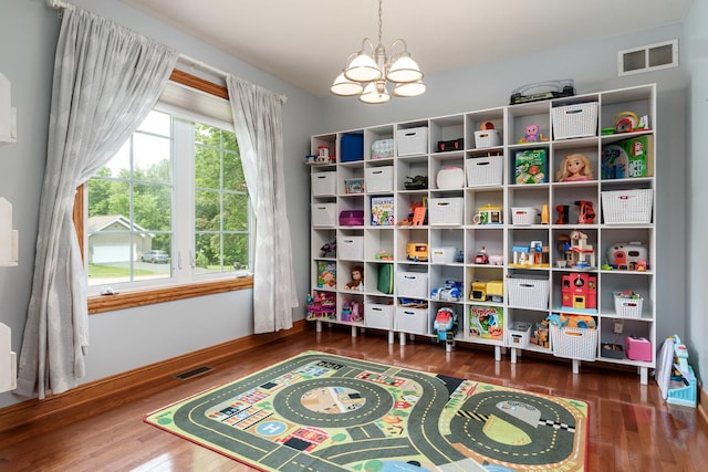 694 Lake Summerset Rd, Davis, IL 61019 - playroom featuring wood finished floors, a chandelier, and baseboards