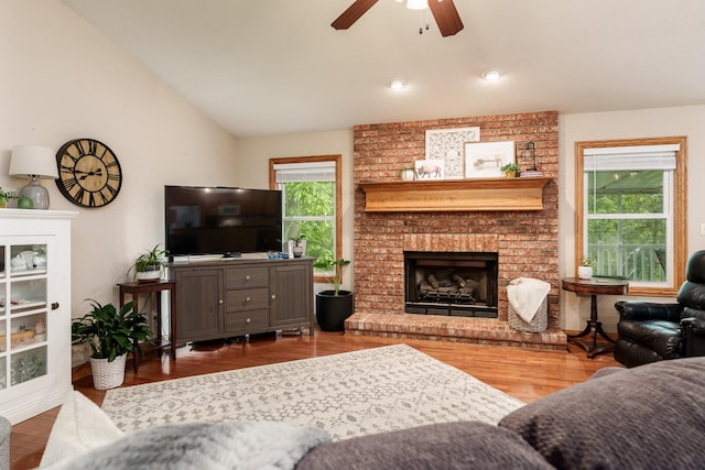 694 Lake Summerset Rd, Davis, IL 61019 - living area featuring a ceiling fan, lofted ceiling, a fireplace, and wood finished floors