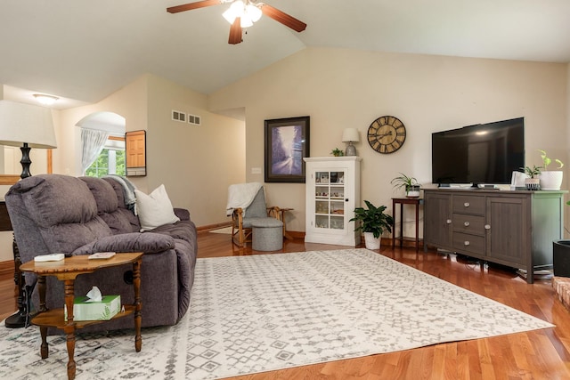 694 Lake Summerset Rd, Davis, IL 61019 - living area featuring lofted ceiling, a ceiling fan, arched walkways, wood finished floors, and baseboards
