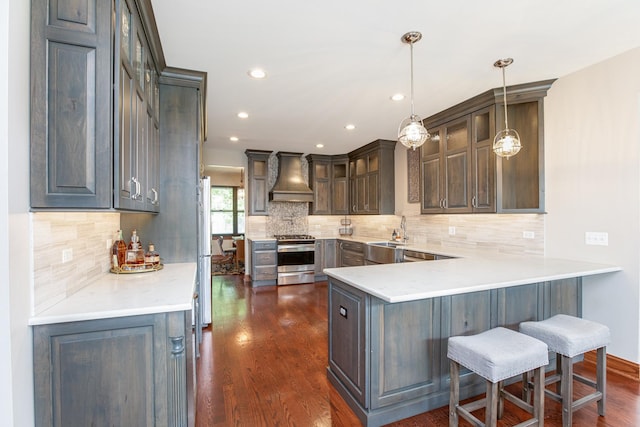 2907 Camden Dr, West Chicago, IL 60185 - kitchen with premium range hood, appliances with stainless steel finishes, a peninsula, dark wood-style floors, and glass insert cabinets