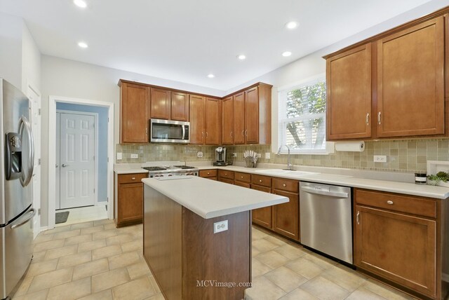 16347 W Cagwin Dr, Lockport, IL 60441 - kitchen featuring stainless steel appliances, light countertops, tasteful backsplash, brown cabinetry, and recessed lighting