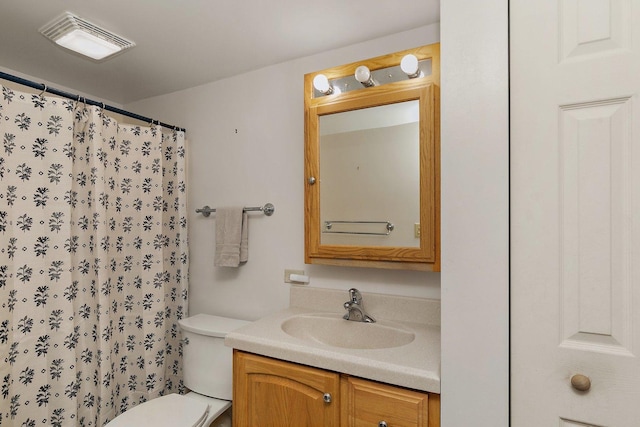 bathroom with vanity, toilet, and a shower with curtain