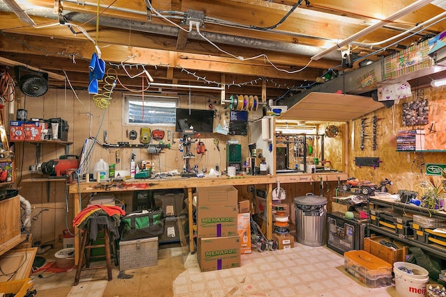below grade area featuring a workshop area and tile patterned floors
