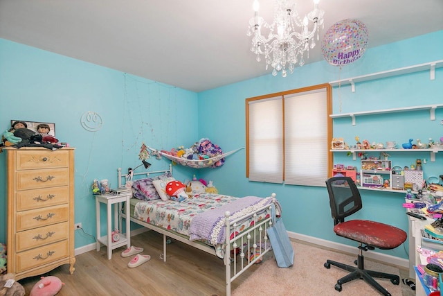 bedroom with a chandelier, baseboards, and wood finished floors