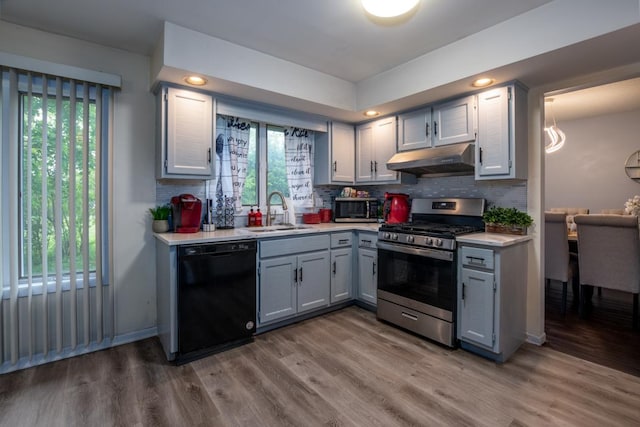 3142 Monterey Dr, Flossmoor, IL 60422 - kitchen with appliances with stainless steel finishes, a sink, under cabinet range hood, light countertops, and gray cabinetry