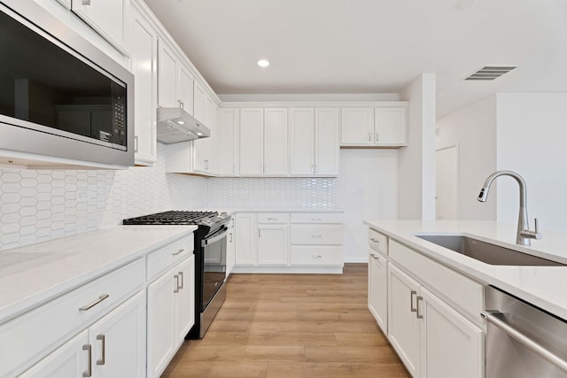 3214 Lincoln Prairie Blvd, Aurora, IL 60503 - kitchen with built in microwave, black range with gas cooktop, dishwasher, range hood, and a sink