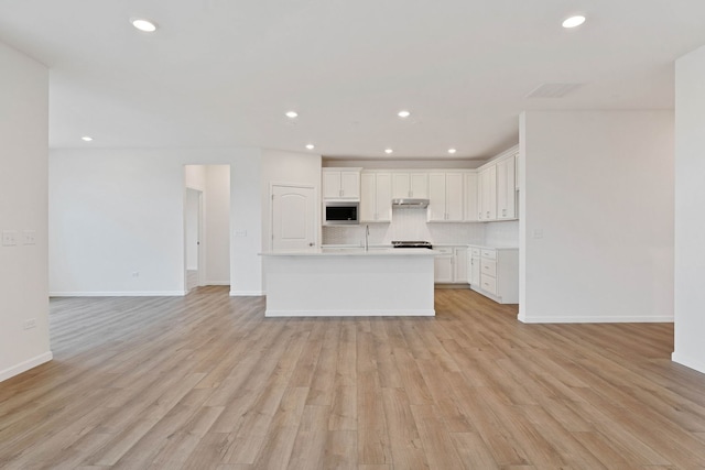 3214 Lincoln Prairie Blvd, Aurora, IL 60503 - kitchen featuring stainless steel microwave, open floor plan, backsplash, light countertops, and recessed lighting