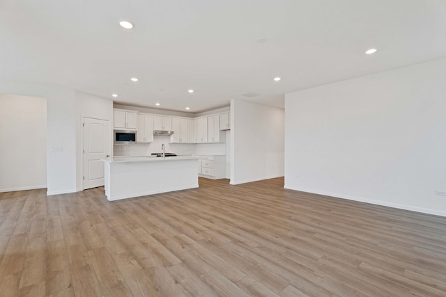 3214 Lincoln Prairie Blvd, Aurora, IL 60503 - unfurnished living room featuring recessed lighting, light wood-type flooring, baseboards, and a sink
