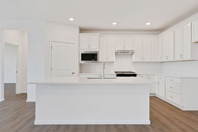 3214 Lincoln Prairie Blvd, Aurora, IL 60503 - kitchen with built in microwave, a sink, stainless steel range oven, a kitchen island with sink, and light wood-style flooring