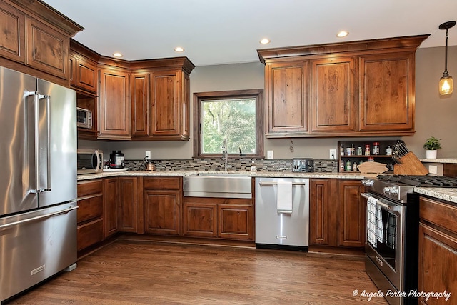 34942 N Gogol Ave, Ingleside, IL 60041 - kitchen with appliances with stainless steel finishes, light stone countertops, dark wood finished floors, recessed lighting, and pendant lighting