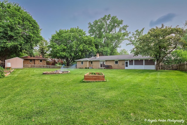 34942 N Gogol Ave, Ingleside, IL 60041 - fenced backyard with a garden, a storage shed, and a sunroom