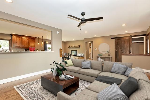 34942 N Gogol Ave, Ingleside, IL 60041 - living room with a barn door, ceiling fan, light wood finished floors, and recessed lighting