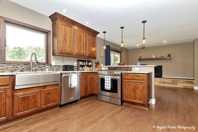 34942 N Gogol Ave, Ingleside, IL 60041 - kitchen with stainless steel appliances, a peninsula, brown cabinets, wood finished floors, and recessed lighting
