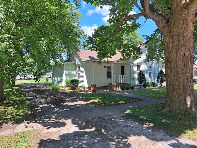 112 W 6th St, Gridley, IL 61744 - obstructed view of property featuring roof with shingles and driveway