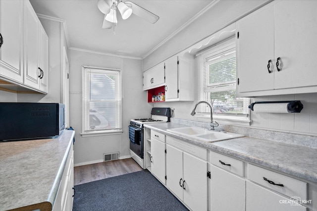 424 Howard Ave, Aurora, IL 60506 - kitchen featuring white range with gas cooktop, a sink, ornamental molding, white cabinets, and black microwave