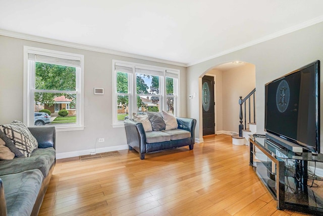 3829 S Austin Blvd, Cicero, IL 60804 - living room featuring arched walkways, healthy amount of natural light, ornamental molding, and baseboards