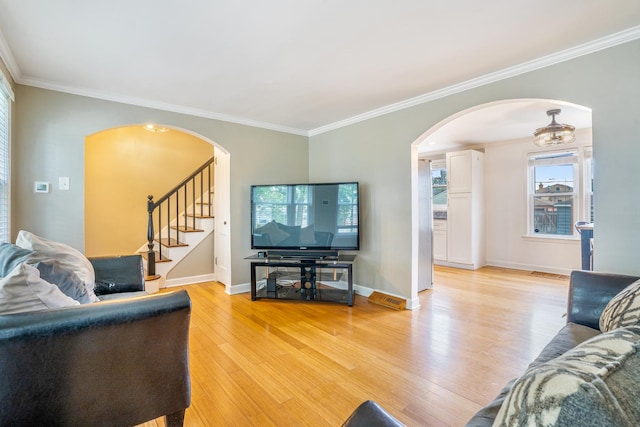 3829 S Austin Blvd, Cicero, IL 60804 - living area with light wood-type flooring, ornamental molding, arched walkways, stairway, and baseboards