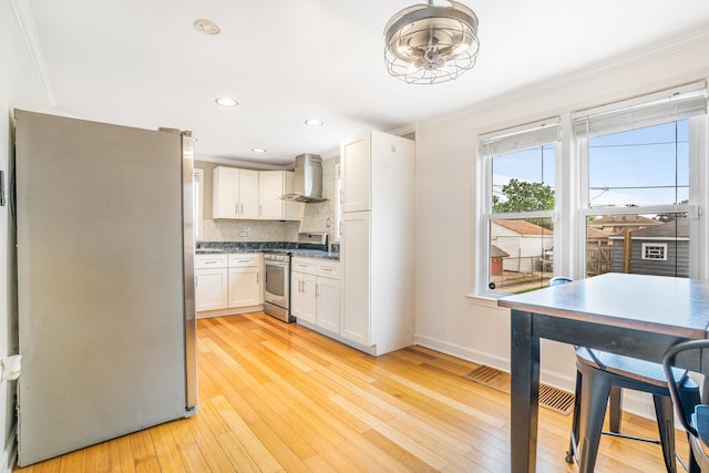 3829 S Austin Blvd, Cicero, IL 60804 - kitchen featuring stainless steel appliances, wall chimney exhaust hood, crown molding, white cabinetry, and light wood finished floors