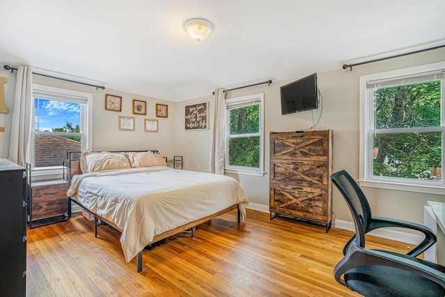 3829 S Austin Blvd, Cicero, IL 60804 - bedroom featuring multiple windows, light wood finished floors, and baseboards