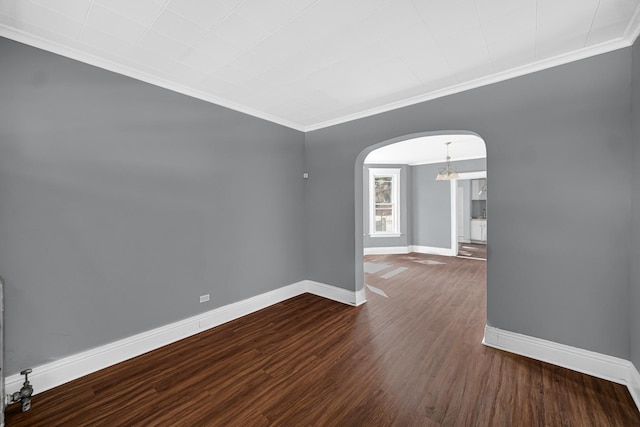 72 E 136th St, Riverdale, IL 60827 - empty room with arched walkways, crown molding, and dark wood finished floors