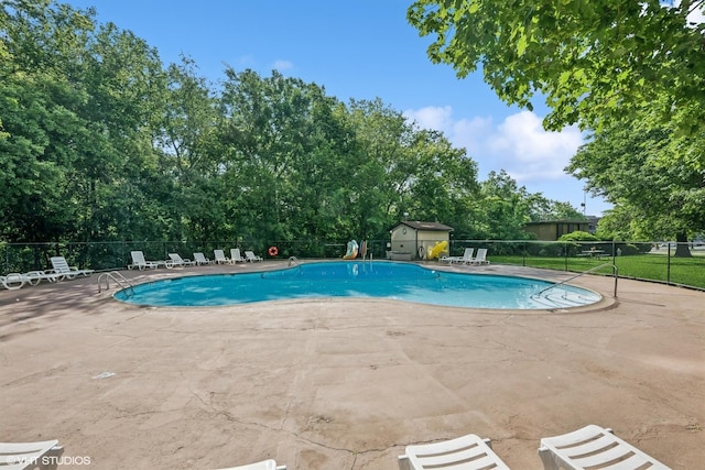 1 Renaissance Pl Unit 3Ph, Palatine, IL 60067 - community pool featuring a patio, view of wooded area, and a storage unit