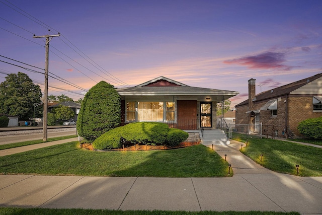 12101 S Lafayette Ave, Chicago, IL 60628 - view of front of home featuring a lawn and covered porch