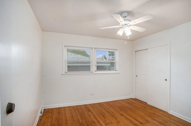 12101 S Lafayette Ave, Chicago, IL 60628 - unfurnished bedroom with light wood finished floors, baseboards, a closet, and ceiling fan