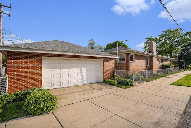 12101 S Lafayette Ave, Chicago, IL 60628 - view of property exterior with a chimney, brick siding, and concrete driveway