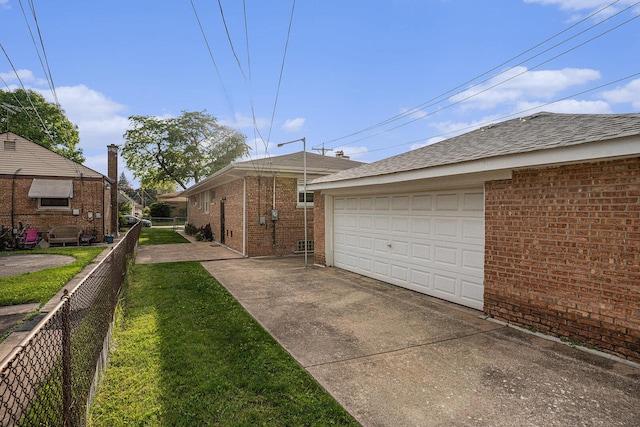 12101 S Lafayette Ave, Chicago, IL 60628 - view of side of home featuring brick siding, a garage, and a shingled roof