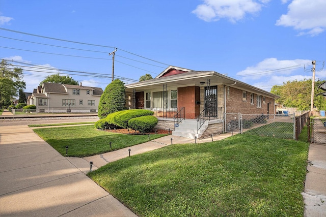 12101 S Lafayette Ave, Chicago, IL 60628 - view of front of house with brick siding, a gate, and covered porch