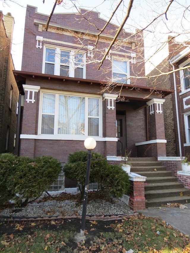7120 S Eberhart Ave, Chicago, IL 60619 - view of front of home with brick siding and covered porch