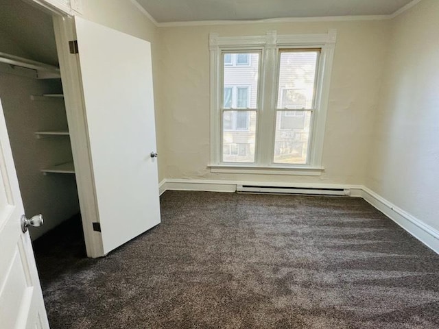 464 S Harrison Ave, Kankakee, IL 60901 - unfurnished bedroom featuring dark carpet, baseboard heating, baseboards, and crown molding