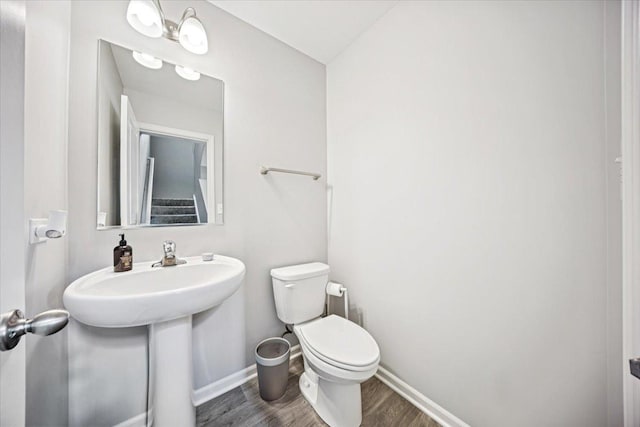 3808 Honeysuckle Ln, Elgin, IL 60124 - bathroom with toilet, wood finished floors, and baseboards