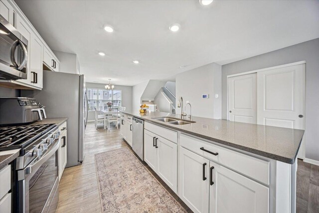 3808 Honeysuckle Ln, Elgin, IL 60124 - kitchen featuring appliances with stainless steel finishes, a sink, light wood-style flooring, white cabinetry, and recessed lighting