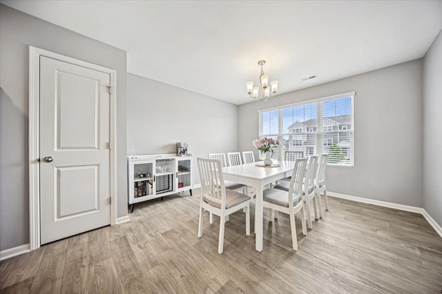 3808 Honeysuckle Ln, Elgin, IL 60124 - dining space featuring a chandelier, light wood-style flooring, and baseboards