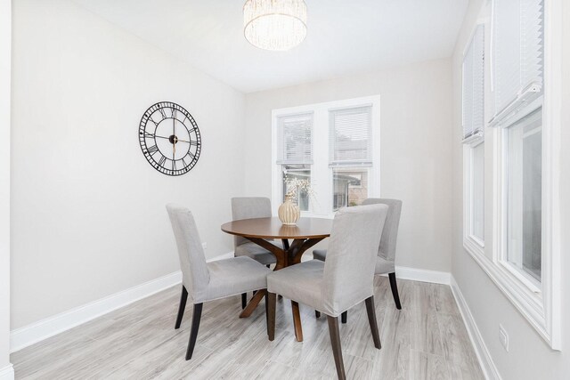 12533 S Lowe Ave, Chicago, IL 60628 - dining room with a chandelier, baseboards, and light wood-style floors