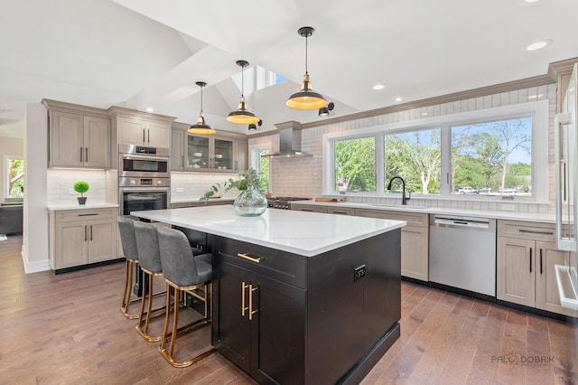 6517 Saddle Ridge Ct, Long Grove, IL 60047 - kitchen with stainless steel appliances, hardwood / wood-style flooring, tasteful backsplash, a kitchen island, and wall chimney range hood